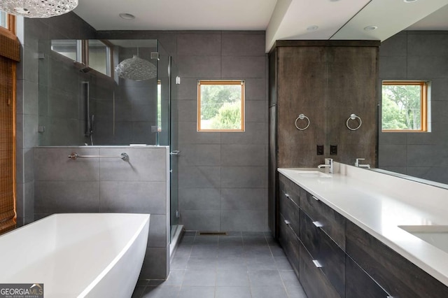 497 Rutherford St, Athens, GA 30606 - bathroom with tile walls, tile patterned floors, a shower stall, a soaking tub, and double vanity