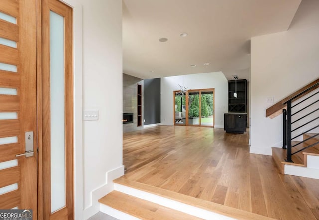 497 Rutherford St, Athens, GA 30606 - entryway with stairs, wood finished floors, a large fireplace, and recessed lighting
