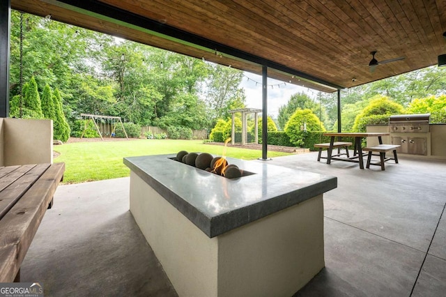 497 Rutherford St, Athens, GA 30606 - fenced backyard featuring area for grilling, a playground, a patio area, ceiling fan, and view of wooded area