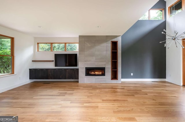 497 Rutherford St, Athens, GA 30606 - unfurnished living room with wood finished floors, plenty of natural light, and a fireplace
