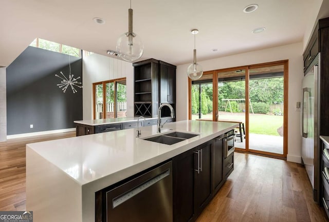 497 Rutherford St, Athens, GA 30606 - kitchen featuring a center island with sink, stainless steel dishwasher, healthy amount of natural light, wood finished floors, and recessed lighting