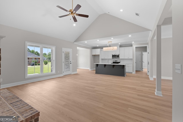 10 Honeysuckle Dr, Claxton, GA 30417 - unfurnished living room with high vaulted ceiling, a ceiling fan, recessed lighting, and light wood-style flooring