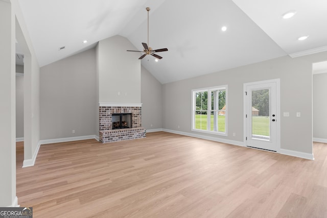 10 Honeysuckle Dr, Claxton, GA 30417 - unfurnished living room featuring a ceiling fan, lofted ceiling, light wood-type flooring, a brick fireplace, and recessed lighting