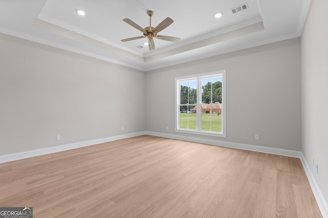 10 Honeysuckle Dr, Claxton, GA 30417 - spare room featuring a tray ceiling, light wood-style floors, a ceiling fan, crown molding, and recessed lighting