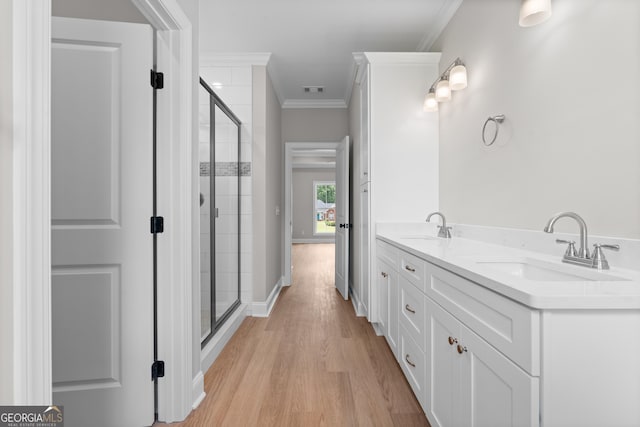 10 Honeysuckle Dr, Claxton, GA 30417 - full bath with ornamental molding, a stall shower, wood finished floors, and double vanity