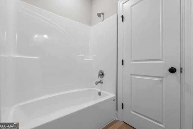 10 Honeysuckle Dr, Claxton, GA 30417 - bathroom with tub / shower combination and wood finished floors