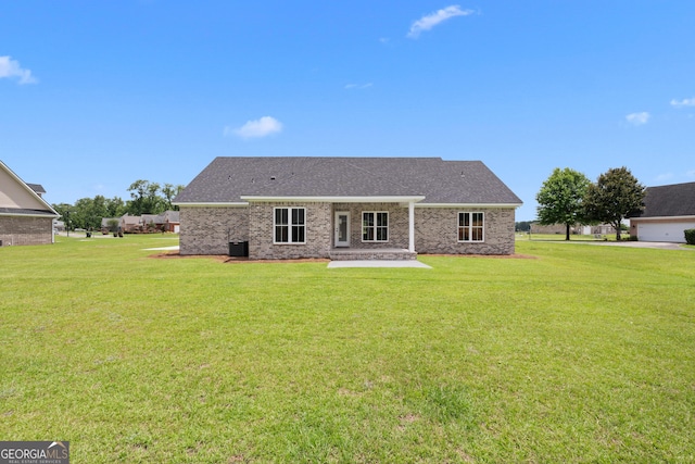 10 Honeysuckle Dr, Claxton, GA 30417 - back of property with a lawn, a patio area, brick siding, and a shingled roof
