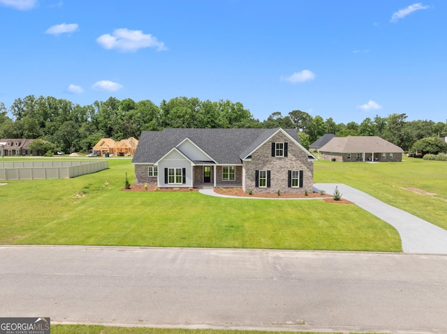 10 Honeysuckle Dr, Claxton, GA 30417 - craftsman house featuring a front lawn, stone siding, and roof with shingles