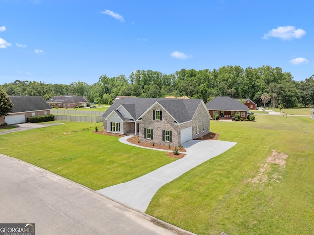 10 Honeysuckle Dr, Claxton, GA 30417 - view of front facade featuring stone siding, concrete driveway, view of scattered trees, and an attached garage