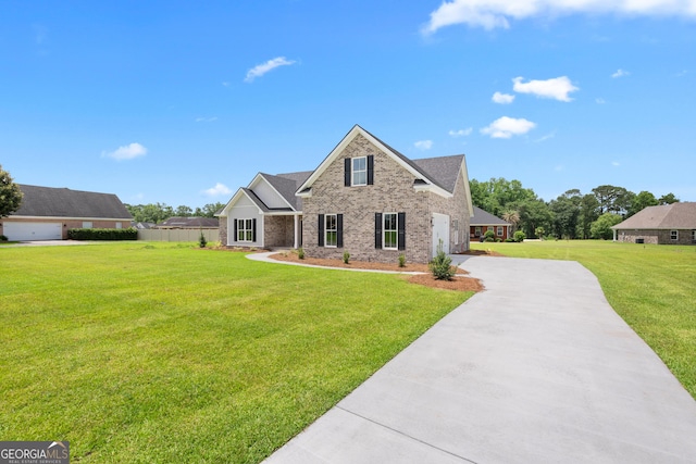 10 Honeysuckle Dr, Claxton, GA 30417 - view of front of home with driveway, brick siding, a front lawn, and a garage