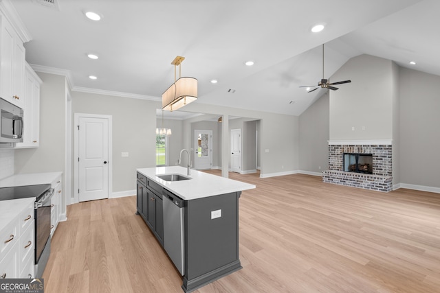 10 Honeysuckle Dr, Claxton, GA 30417 - kitchen featuring appliances with stainless steel finishes, white cabinets, light countertops, a ceiling fan, and hanging light fixtures