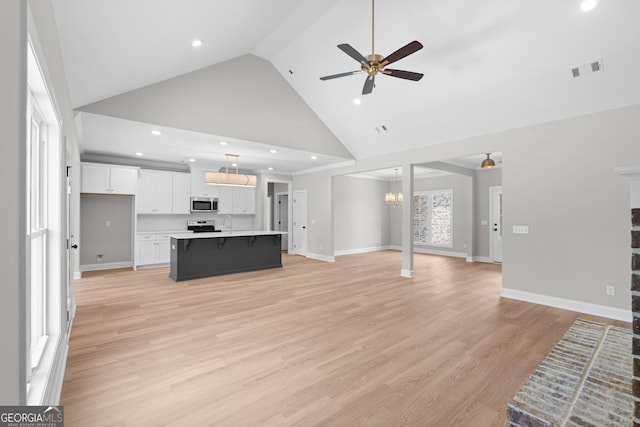 10 Honeysuckle Dr, Claxton, GA 30417 - unfurnished living room featuring high vaulted ceiling, ceiling fan, a chandelier, light wood-style flooring, and recessed lighting