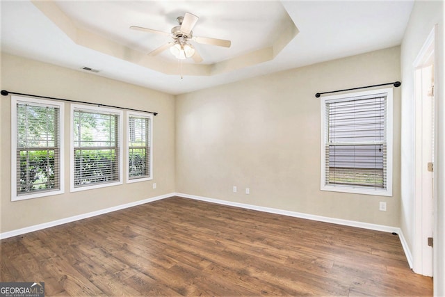 113 Macalester Dr, Newnan, GA 30265 - empty room with a tray ceiling, dark wood-style floors, and ceiling fan