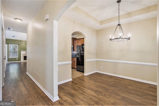 113 Macalester Dr, Newnan, GA 30265 - unfurnished dining area featuring dark wood-style floors, a chandelier, and arched walkways