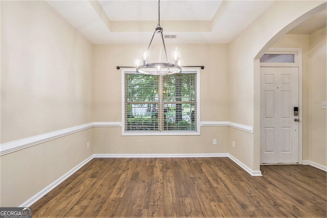 113 Macalester Dr, Newnan, GA 30265 - unfurnished dining area featuring arched walkways, a chandelier, dark wood-style floors, and a raised ceiling