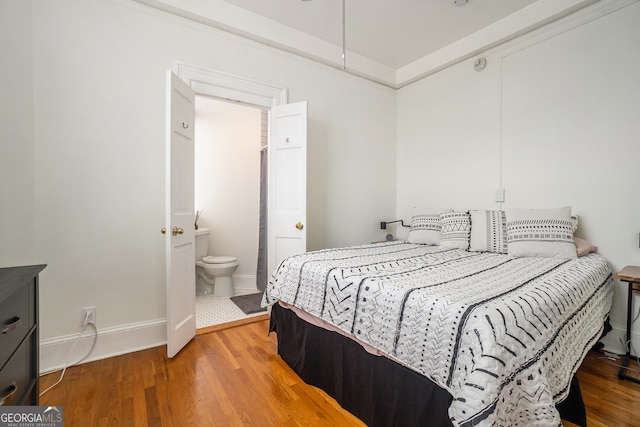 75 Ponce De Leon Ave NE Unit 1004, Atlanta, GA 30308 - bedroom featuring wood finished floors and ensuite bath