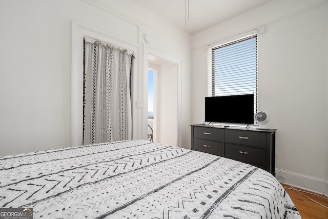 75 Ponce De Leon Ave NE Unit 1004, Atlanta, GA 30308 - bedroom with baseboards and wood finished floors