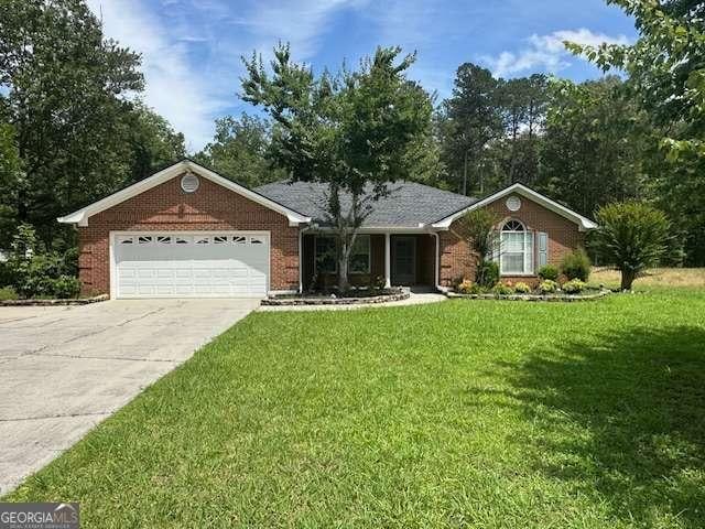 3579 Garden Lakes Pkwy NW, Rome, GA 30165 - ranch-style home featuring an attached garage, driveway, a front lawn, and brick siding