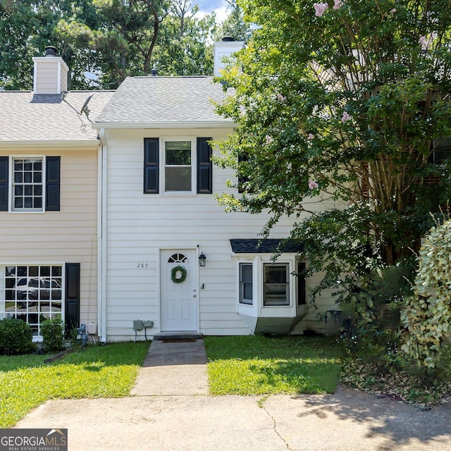 289 Westland Way SW, Marietta, GA 30064 - townhome / multi-family property with a chimney, a front yard, and a shingled roof