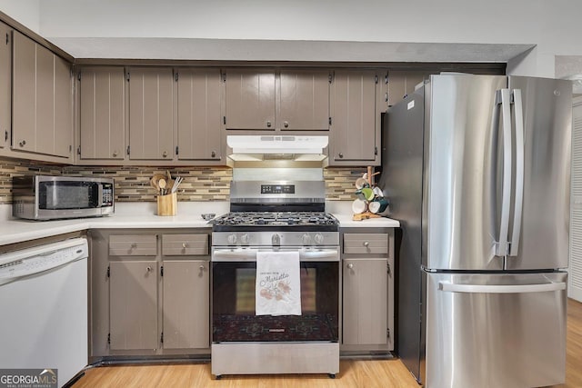 289 Westland Way SW, Marietta, GA 30064 - kitchen featuring appliances with stainless steel finishes, under cabinet range hood, light countertops, and gray cabinets