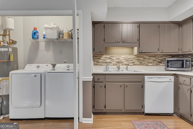 289 Westland Way SW, Marietta, GA 30064 - washroom featuring separate washer and dryer, light wood-type flooring, and gas water heater