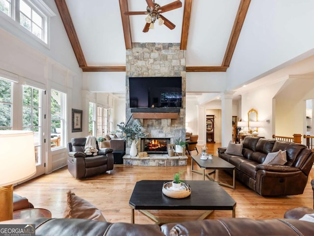 2392 Crimson King Dr, Braselton, GA 30517 - living room with a fireplace, high vaulted ceiling, a ceiling fan, plenty of natural light, and beam ceiling
