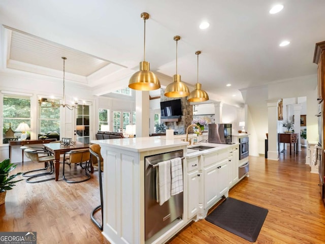 2392 Crimson King Dr, Braselton, GA 30517 - kitchen featuring stainless steel appliances, a warming drawer, light countertops, light wood finished floors, and decorative light fixtures