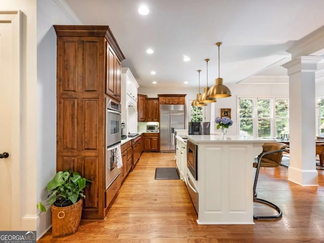 2392 Crimson King Dr, Braselton, GA 30517 - kitchen with built in appliances, light countertops, light wood-style floors, recessed lighting, and a kitchen island