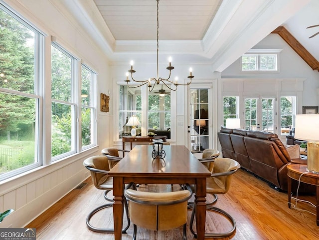 2392 Crimson King Dr, Braselton, GA 30517 - dining room featuring light wood-type flooring, a chandelier, a raised ceiling, french doors, and crown molding