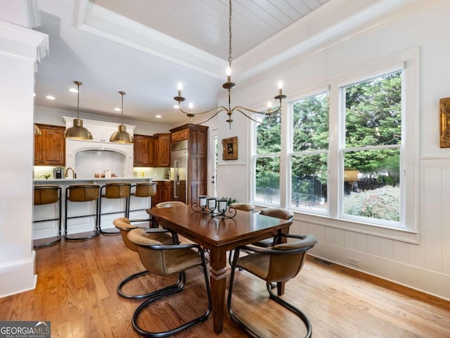 2392 Crimson King Dr, Braselton, GA 30517 - dining room with plenty of natural light, light wood finished floors, ornamental molding, a decorative wall, and a tray ceiling