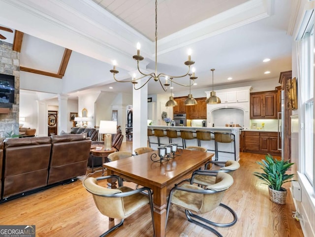 2392 Crimson King Dr, Braselton, GA 30517 - dining room with light wood finished floors, ornate columns, recessed lighting, a fireplace, and crown molding