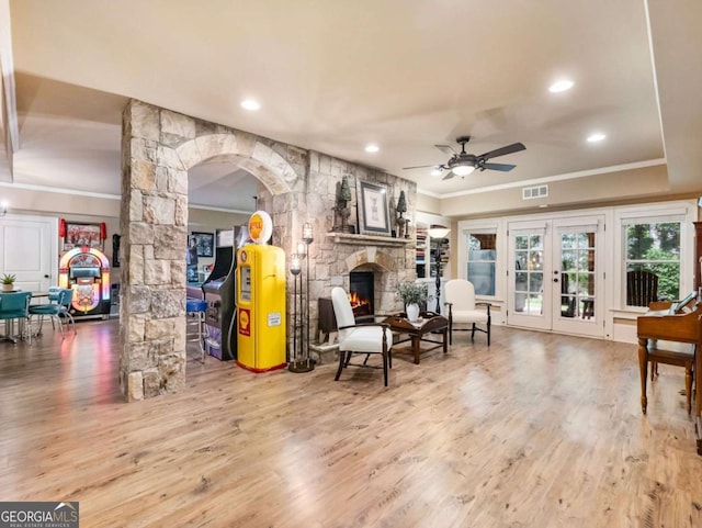 2392 Crimson King Dr, Braselton, GA 30517 - living room with decorative columns, ornamental molding, a fireplace, ceiling fan, and wood finished floors