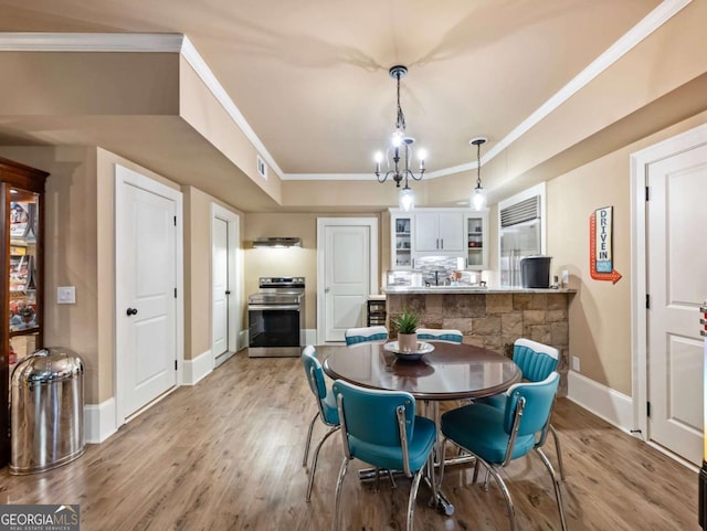 2392 Crimson King Dr, Braselton, GA 30517 - dining area featuring crown molding, light wood-type flooring, and a chandelier