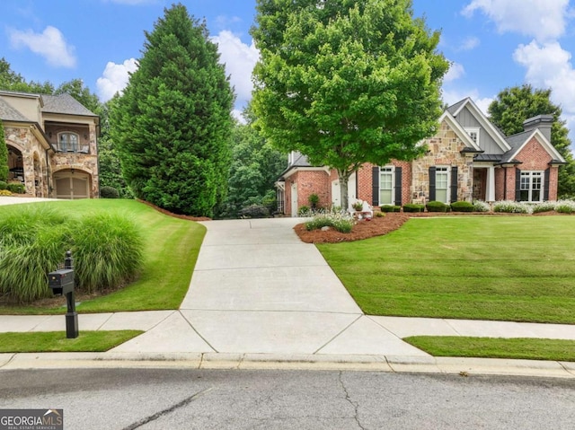 2392 Crimson King Dr, Braselton, GA 30517 - view of front of house featuring board and batten siding, stone siding, a front lawn, and concrete driveway
