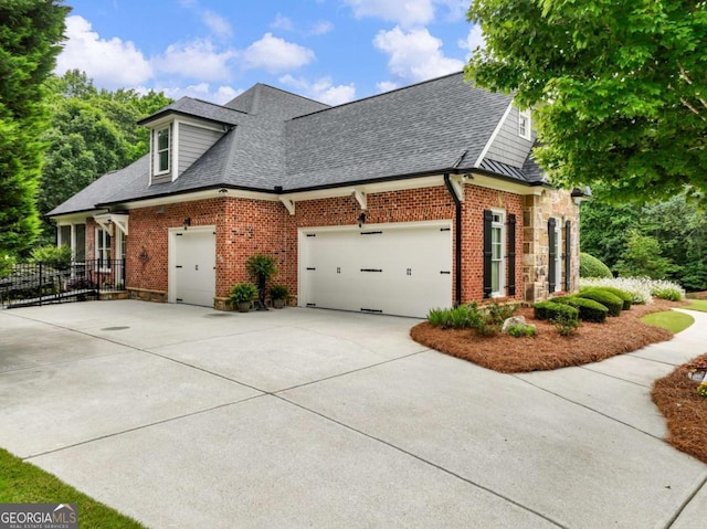 2392 Crimson King Dr, Braselton, GA 30517 - view of side of home with concrete driveway, roof with shingles, brick siding, and an attached garage