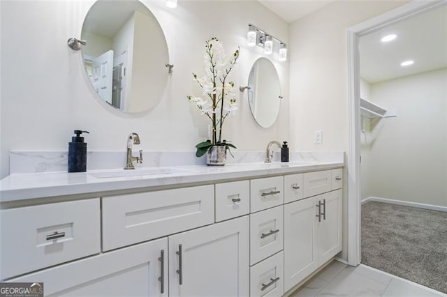 1270 Graymont Dr, Atlanta, GA 30310 - full bathroom with double vanity, marble finish floors, a walk in closet, and recessed lighting