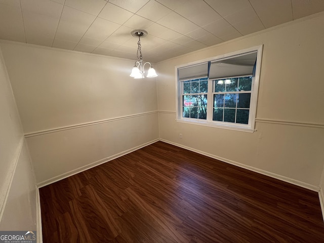 9 Henry St, Statesboro, GA 30458 - empty room featuring ornamental molding, dark wood-style floors, and a chandelier