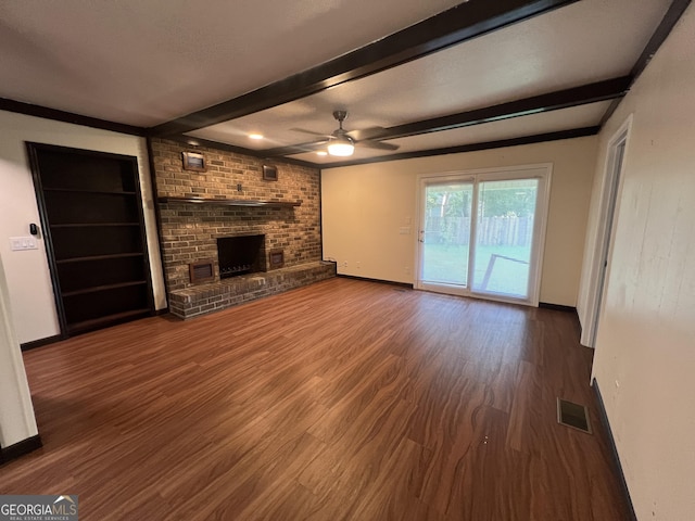 9 Henry St, Statesboro, GA 30458 - unfurnished living room featuring beamed ceiling, wood finished floors, a ceiling fan, and a brick fireplace