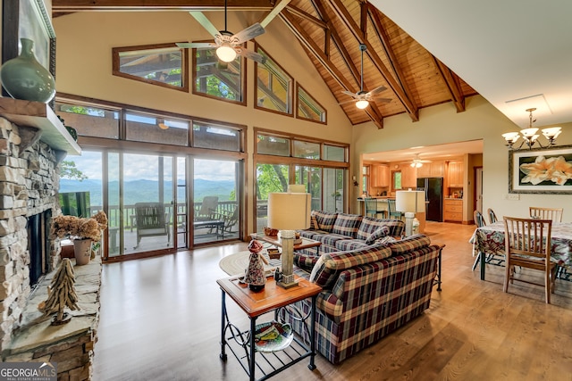 4 Dean Ln, Tiger, GA 30576 - living area with ceiling fan, high vaulted ceiling, a chandelier, a fireplace, and light wood-style floors