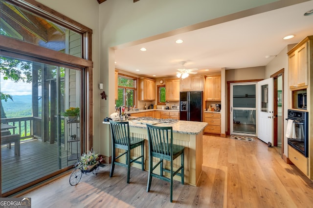 4 Dean Ln, Tiger, GA 30576 - kitchen with black appliances, a peninsula, light wood-style floors, light brown cabinets, and recessed lighting
