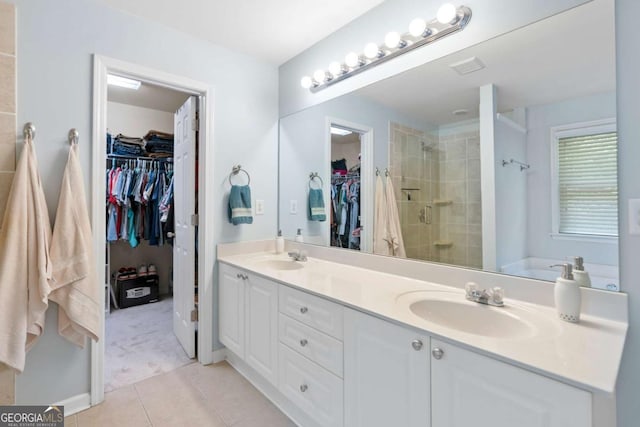 1609 Vinery Ln SE, Mableton, GA 30126 - full bath featuring double vanity, a shower stall, tile patterned floors, and a walk in closet