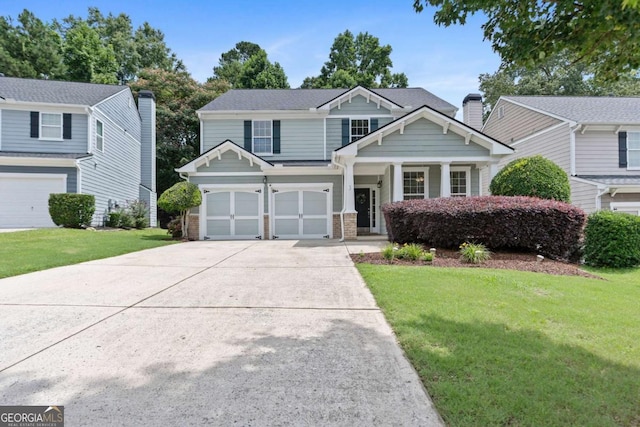 1609 Vinery Ln SE, Mableton, GA 30126 - view of front of home featuring concrete driveway, a front yard, a garage, and a porch