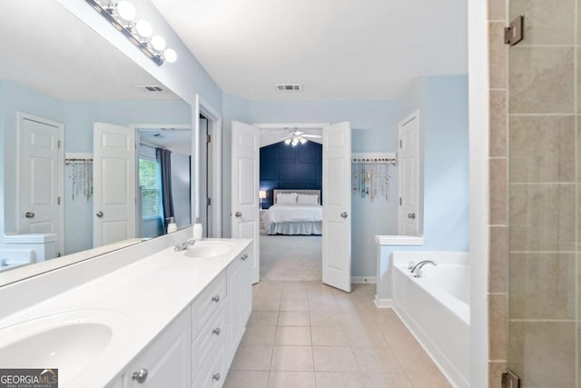 1609 Vinery Ln SE, Mableton, GA 30126 - bathroom featuring ceiling fan, double vanity, tile patterned floors, a bath, and a shower stall