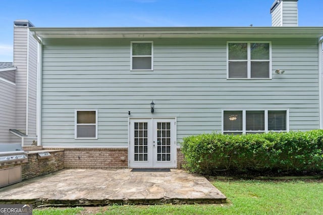 1609 Vinery Ln SE, Mableton, GA 30126 - back of house with french doors, a patio area, a chimney, exterior kitchen, and brick siding