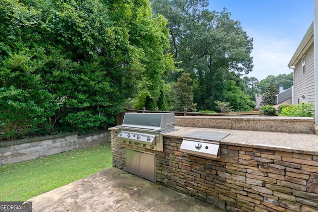 1609 Vinery Ln SE, Mableton, GA 30126 - view of patio with exterior kitchen, concrete driveway, and a garage