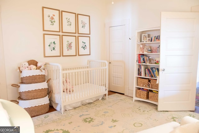 1557 18th Ave, Columbus, GA 31901 - bedroom featuring wood finished floors and a nursery area