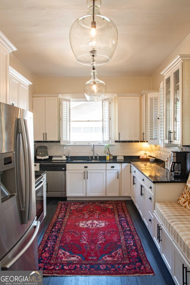 1557 18th Ave, Columbus, GA 31901 - kitchen featuring stainless steel appliances, dark wood-type flooring, backsplash, and glass insert cabinets