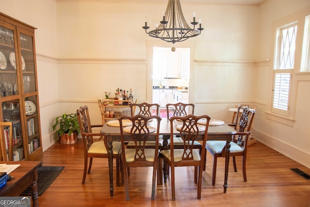 1557 18th Ave, Columbus, GA 31901 - dining space featuring wood finished floors and a chandelier