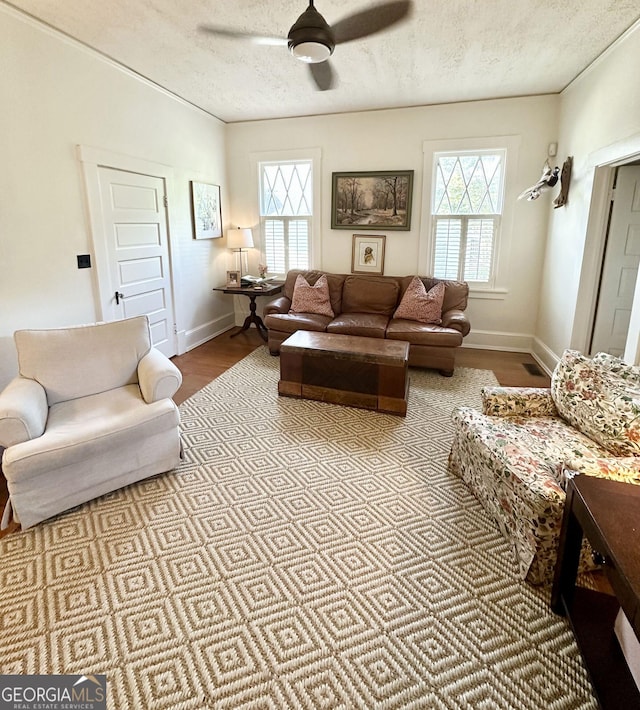 1557 18th Ave, Columbus, GA 31901 - living room featuring a textured ceiling, ceiling fan, and wood finished floors