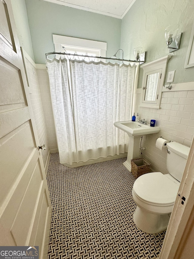 1557 18th Ave, Columbus, GA 31901 - bathroom featuring shower / tub combo, tile walls, wainscoting, and ornamental molding